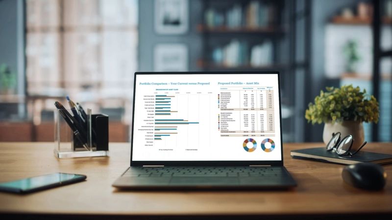 Laptop open with charts on the screen.