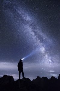 search for investments concept of a person looking at night sky