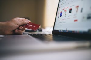 protecting your identity showing online shopping with a hand holding a credit card