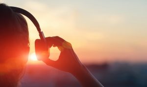 podcasts-girl-headphones-sunset